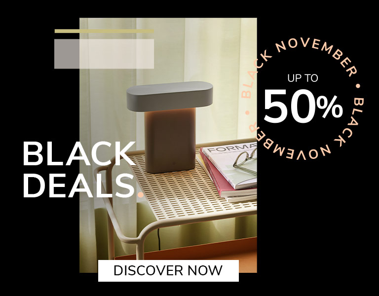 Elegant designer table lamp on natural stone base with gold stem and white shade, promoting Black November sale – up to 40% off with text ‘First Black Deals’ and ‘Discover More’ button.
